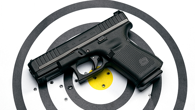 Gun and target with shot bullseye