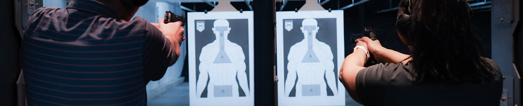 Picture of two people shooting side by side with targets in distance