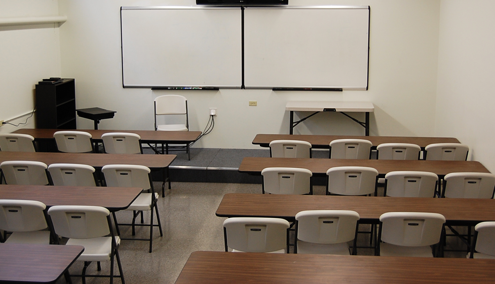 image of classroom with chairs, whiteboard and tv