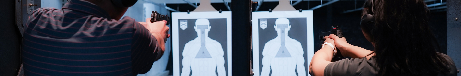 Picture of two people shooting side by side with targets in distance