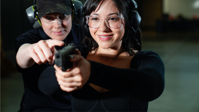 woman being taught how to look through her sights