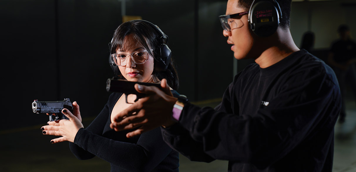 man and woman shooting guns