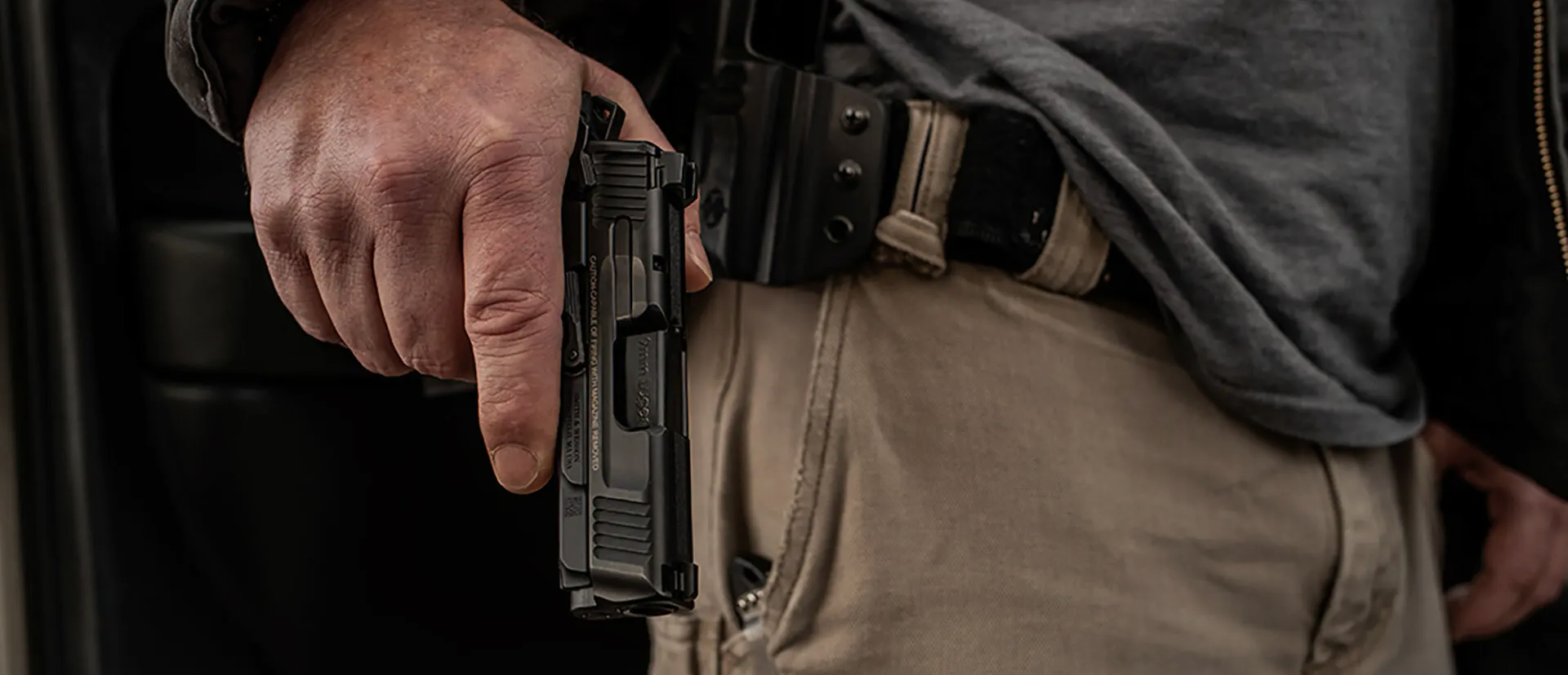 Man with a handgun held down by his hip