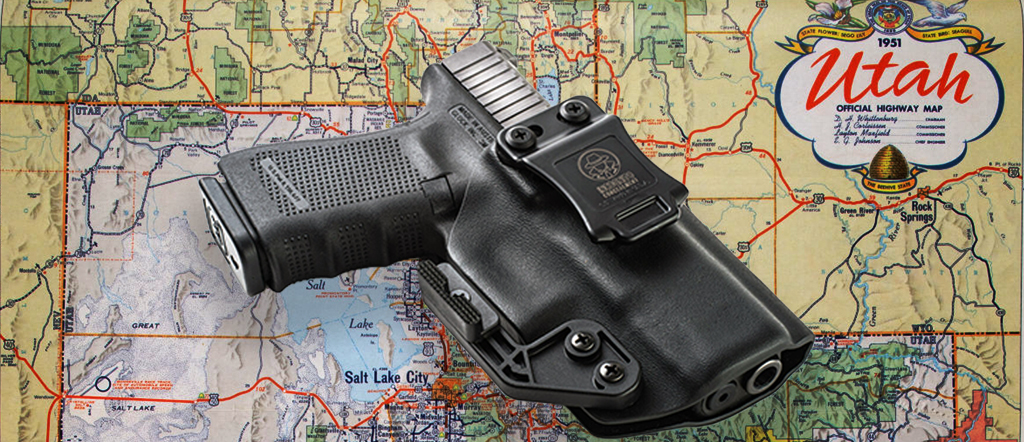 Map of Utah with a handgun laying on top of it