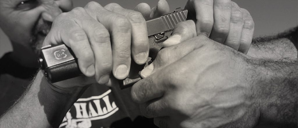 Two men fighting over a handgun