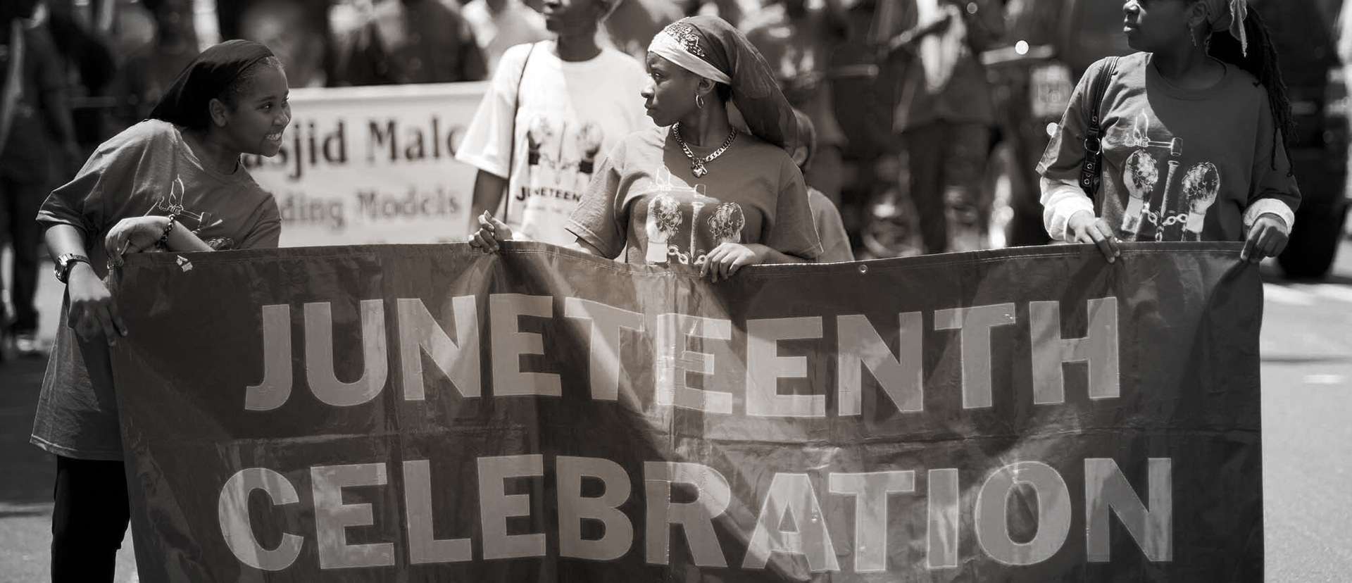 Black and white image of marchers celebrating Juneteenth