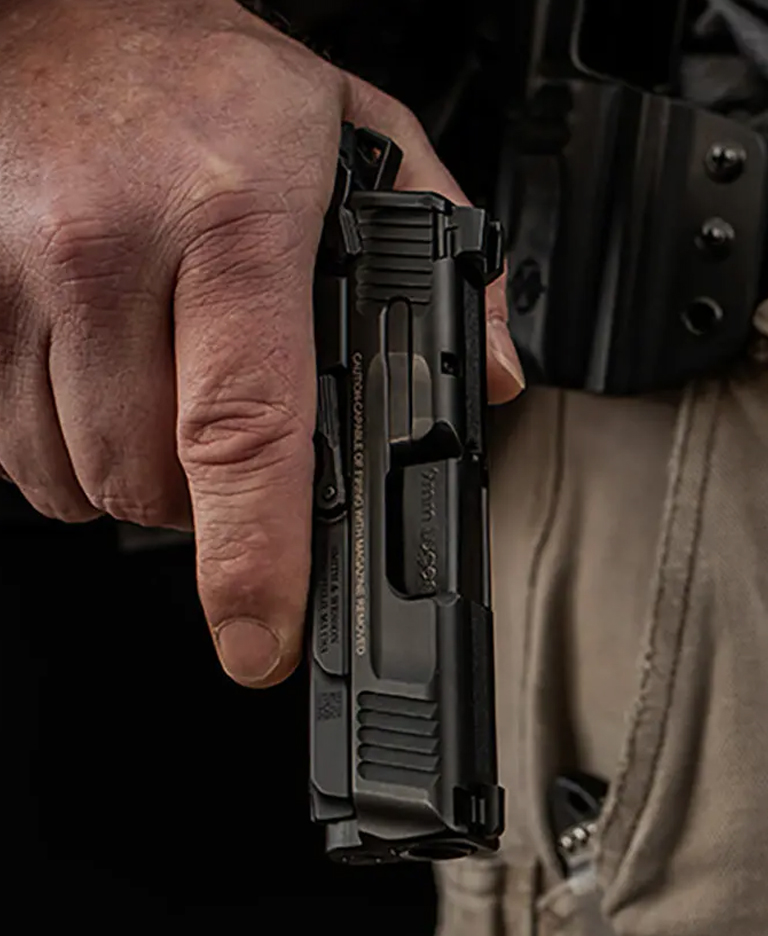 Man holding a pistol by his side