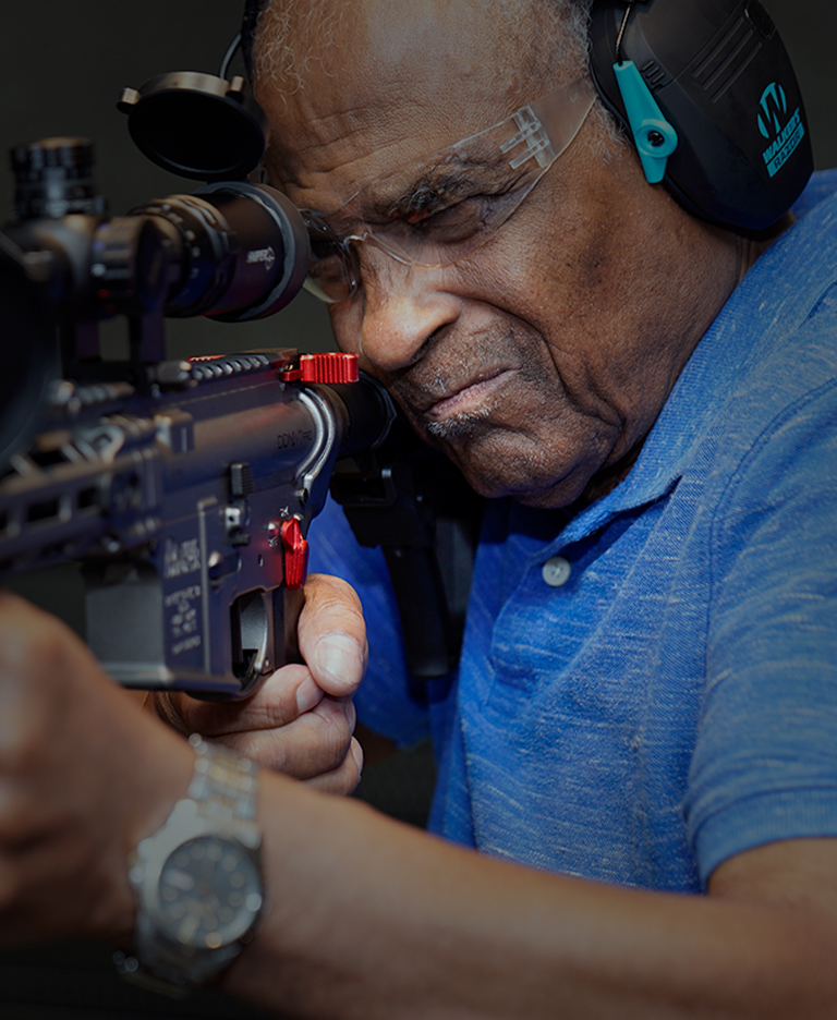 Man shooting rifle