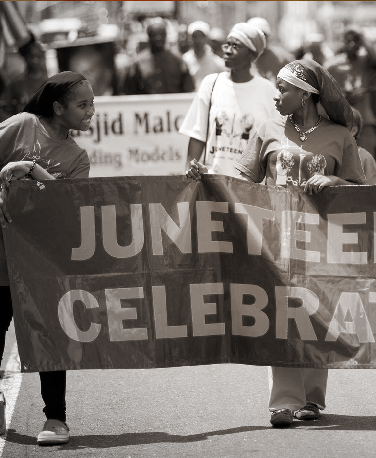 Black and white image of marchers celebrating Juneteenth