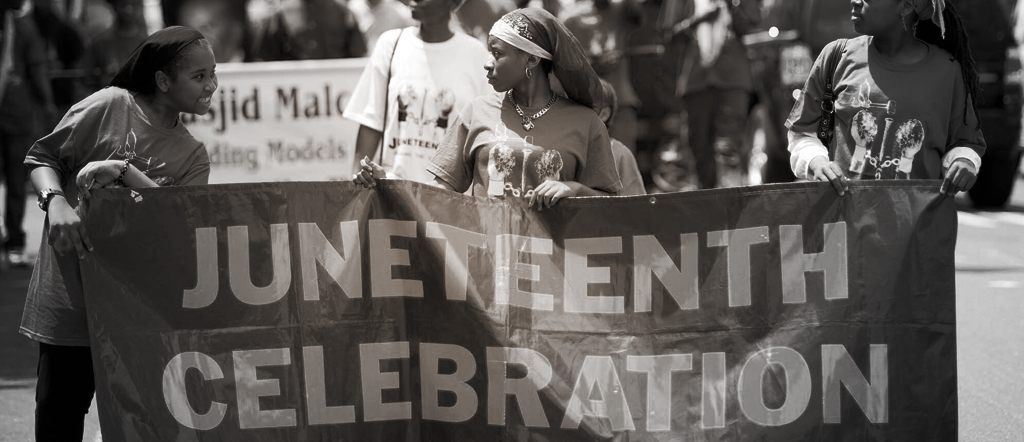 Black and white image of marchers celebrating Juneteenth